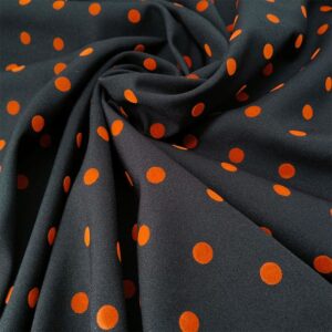 Tela en negro con lunar naranja quemado