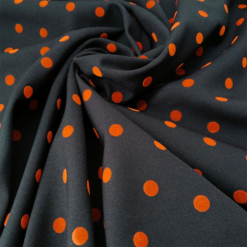 Tela en negro con lunar naranja quemado